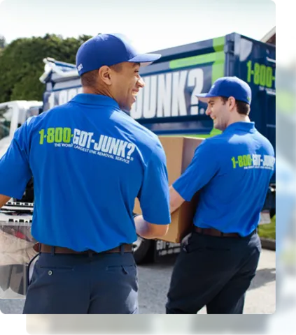 1-800-GOT-JUNK? team picking up junk to bring to junk removal truck