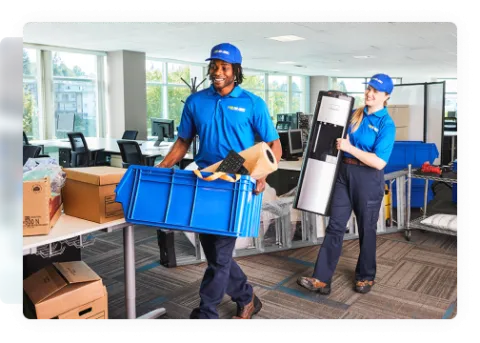 Two 1-800-GOT-JUNK? team members removing junk inside a business 