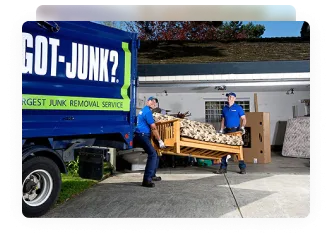 1-800-GOT-JUNK? team picking up old couch to put in junk removal truck